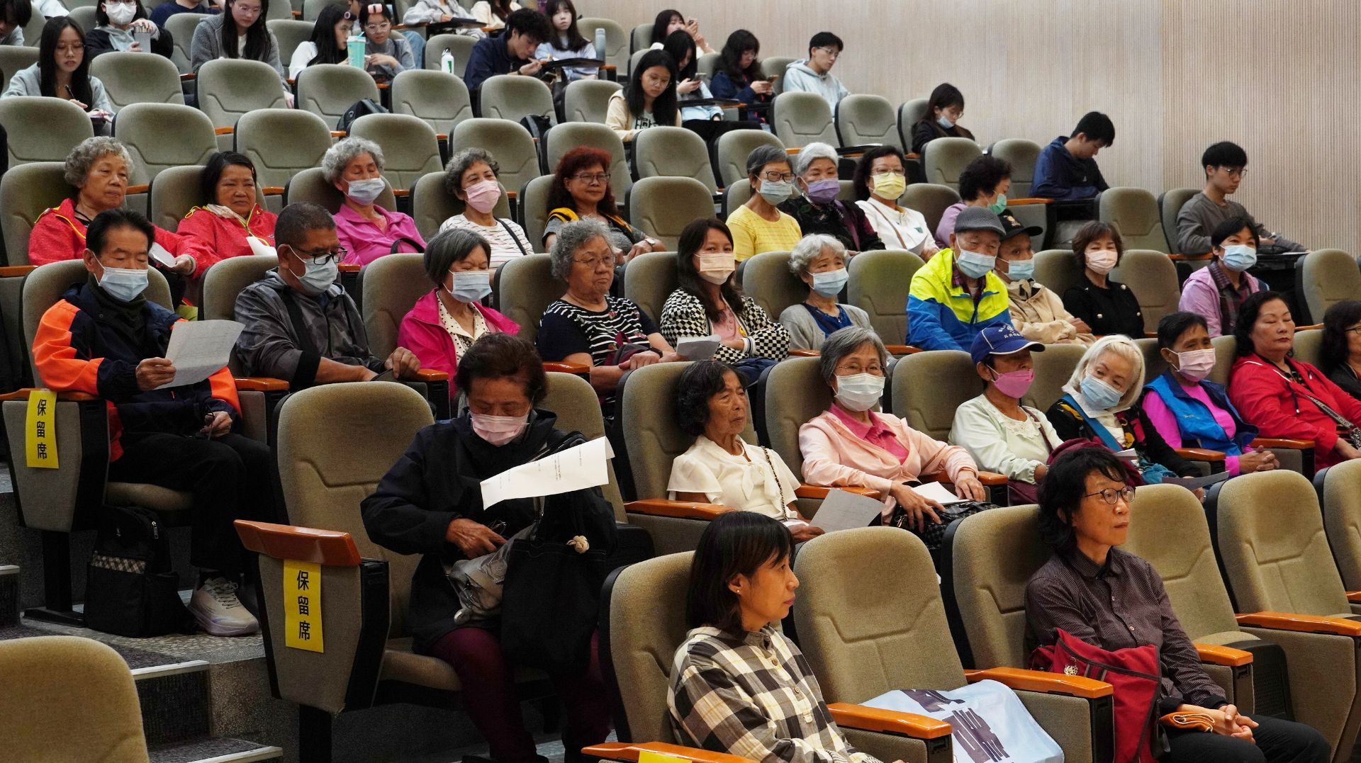 三峽區礁溪里辦公處據點長輩與學生一起聆聽鋼琴演奏會。